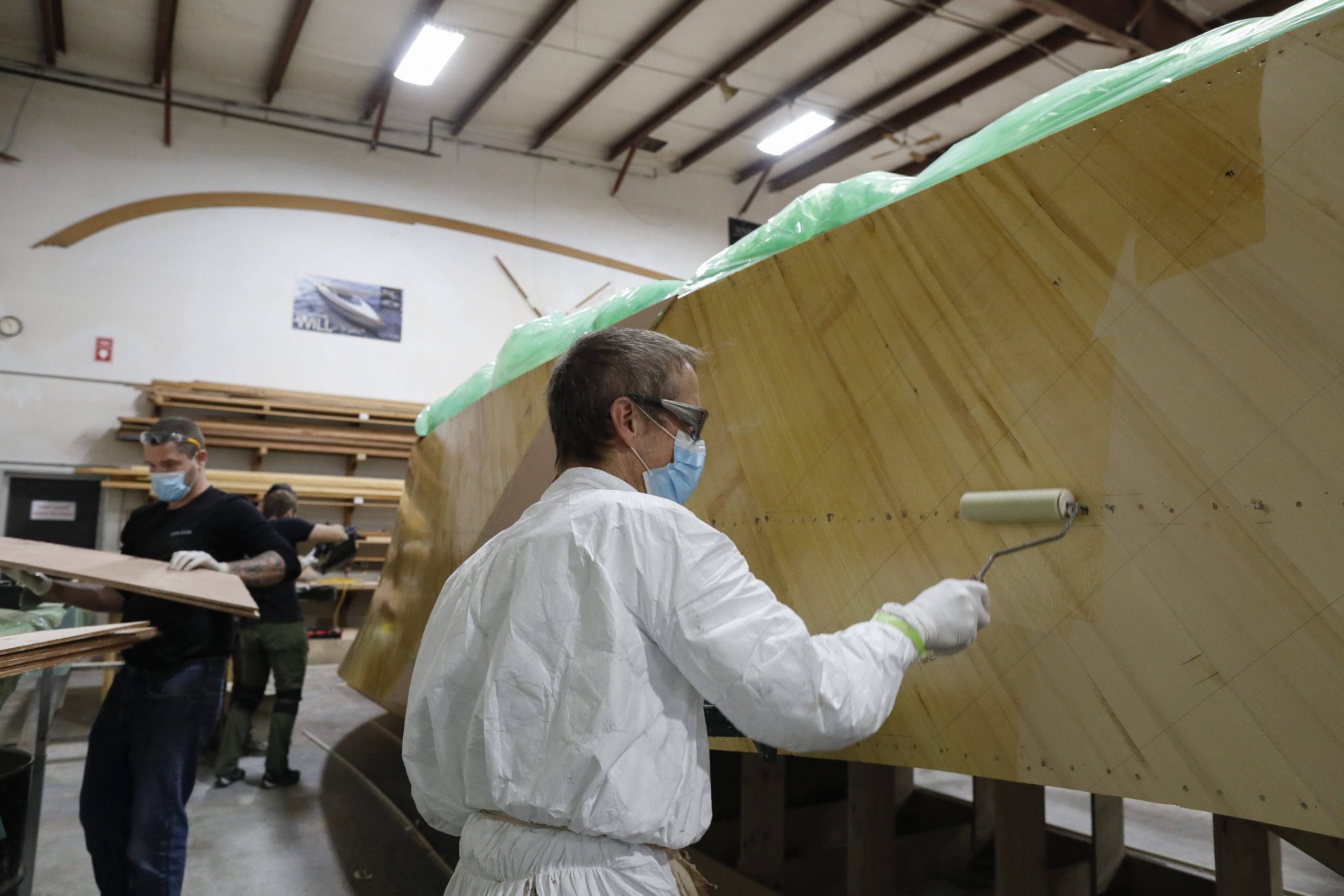 rolling epoxy on a boat hull