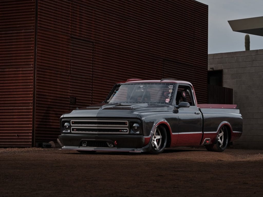 Dropped black and red truck parked on a road