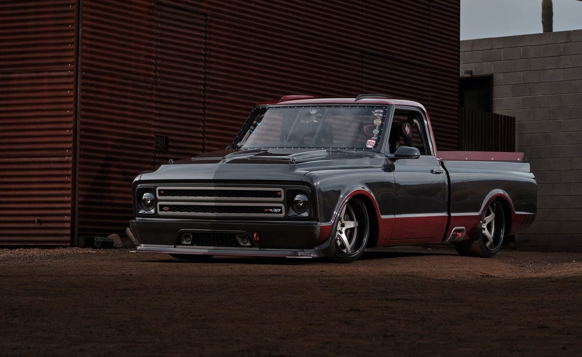 Dropped black and red truck parked on a road