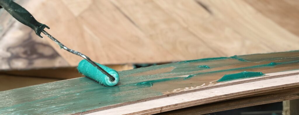 Epoxy is applied to a wooden surface.